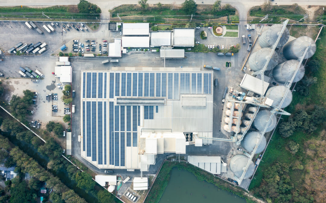 image taken from overhead of a manufacturing building with solar installed on the roof.