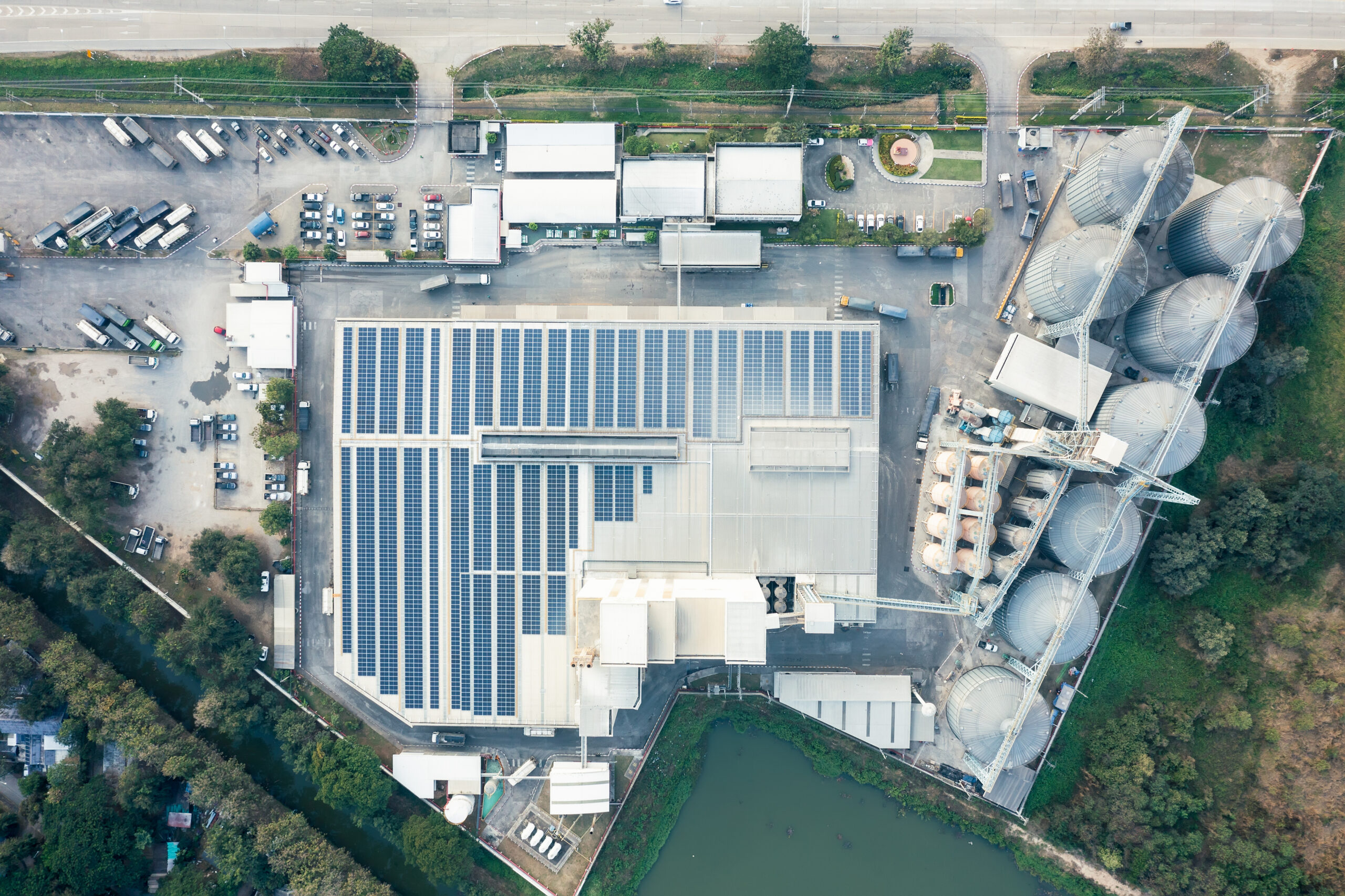 image taken from overhead of a manufacturing building with solar installed on the roof.